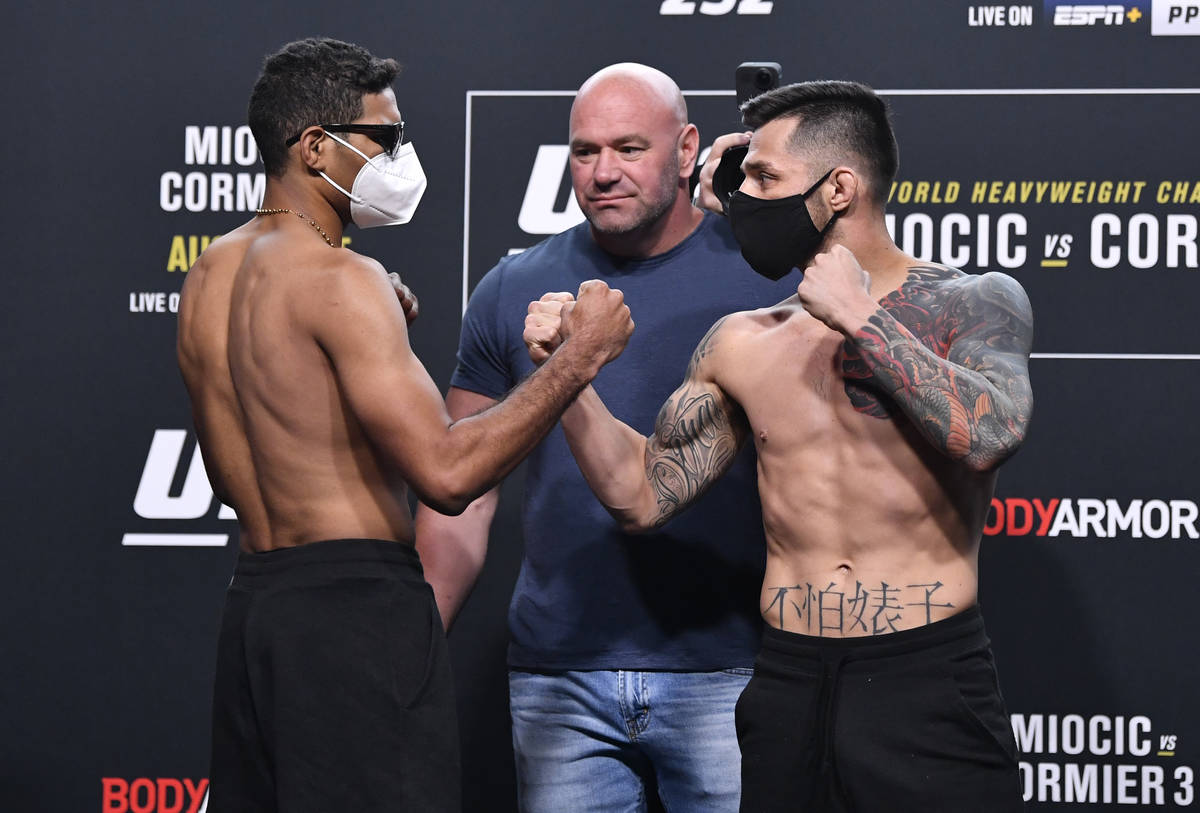 (L-R) Opponents Herbert Burns of Brazil and Daniel Pineda face off during the UFC 252 weigh-in ...