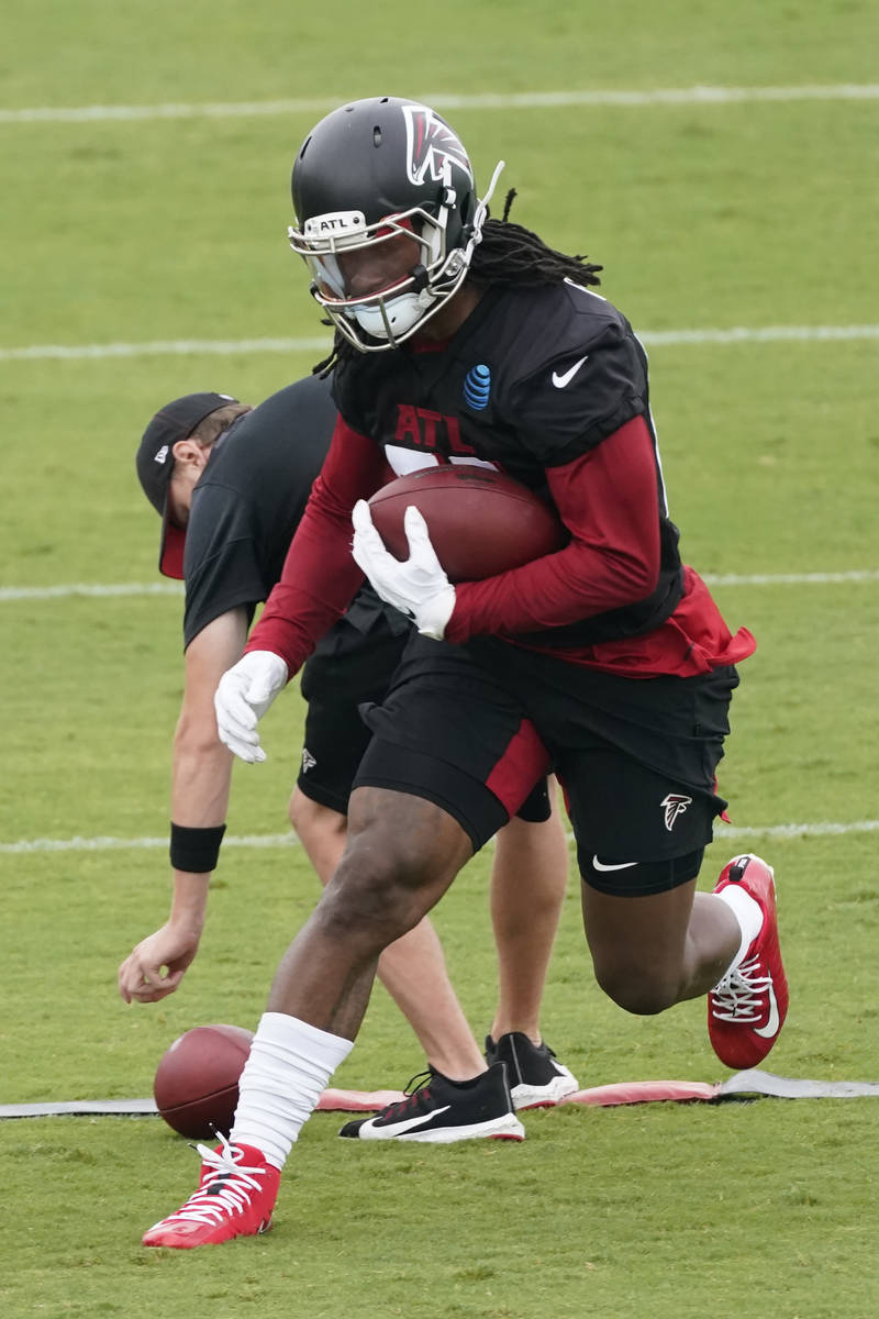 Atlanta Falcons running back Todd Gurley II (21) runs a drill during an NFL football training c ...