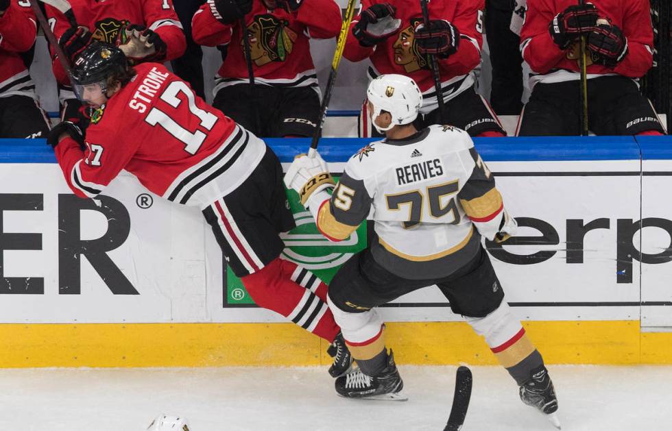 Vegas Golden Knights' Ryan Reaves (75) checks Chicago Blackhawks' Dylan Strome (17) during the ...