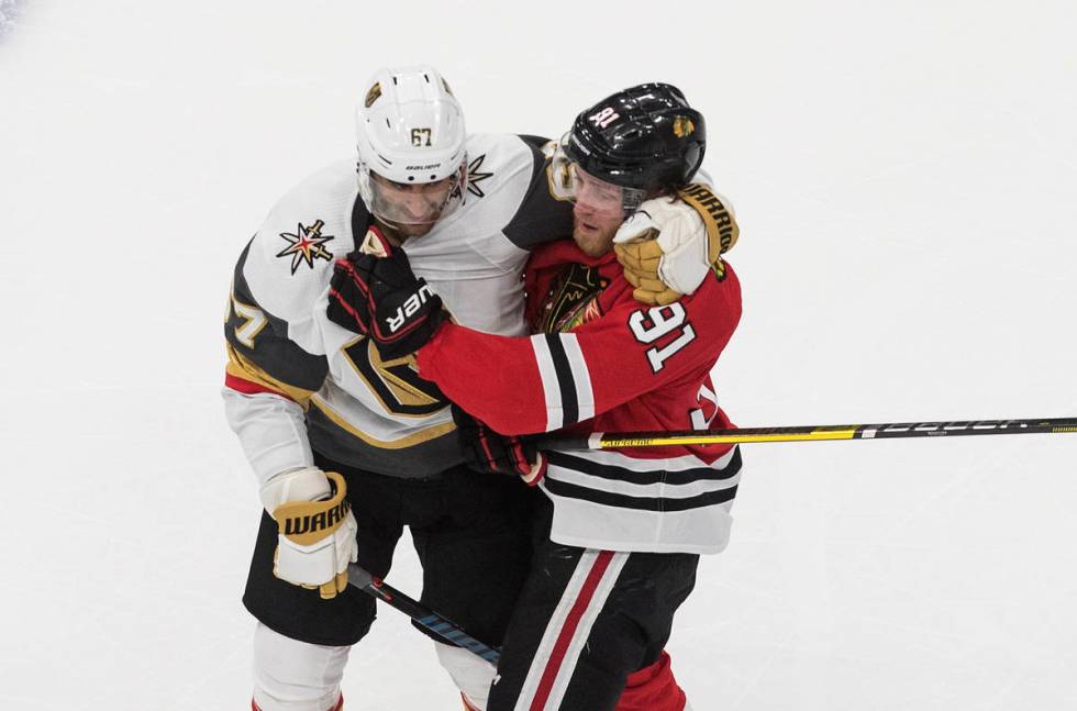 Vegas Golden Knights' Max Pacioretty (67) and Chicago Blackhawks' Drake Caggiula (91) tussle du ...