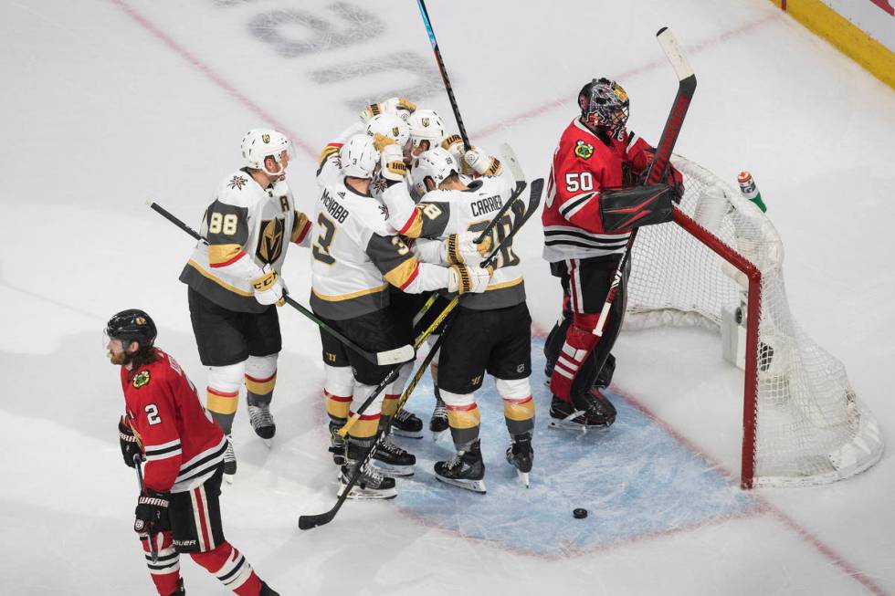 Vegas Golden Knights celebrate a goal as Chicago Blackhawks goalie Corey Crawford (50) and Dunc ...