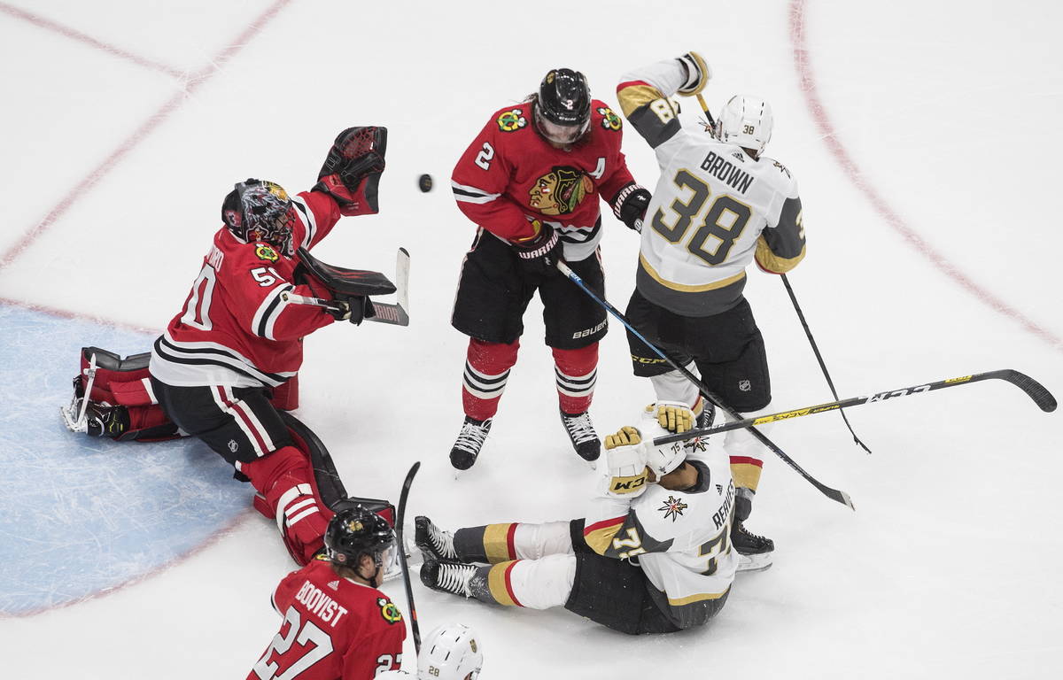 Vegas Golden Knights' Ryan Reaves (75) and Patrick Brown (38) and Chicago Blackhawks' Duncan Ke ...