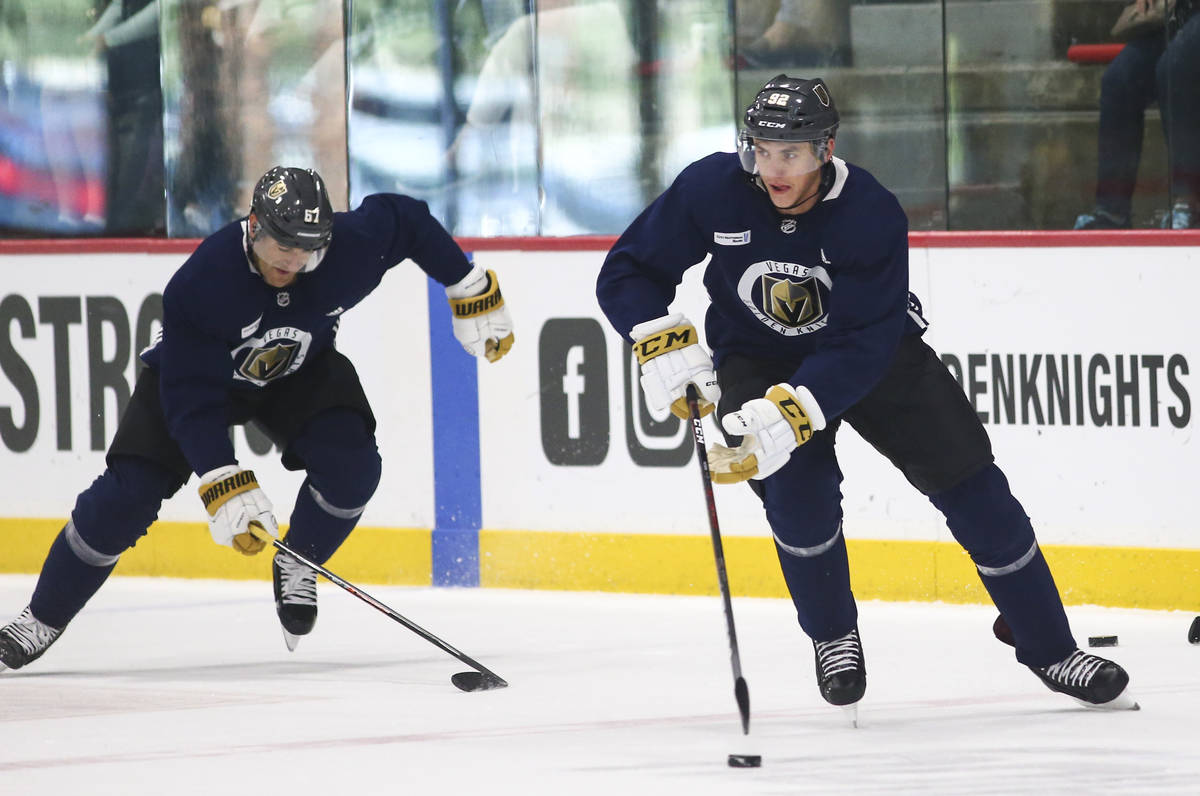 Golden Knights left wing Tomas Nosek (92) skates in front of Golden Knights left wing Max Pacio ...