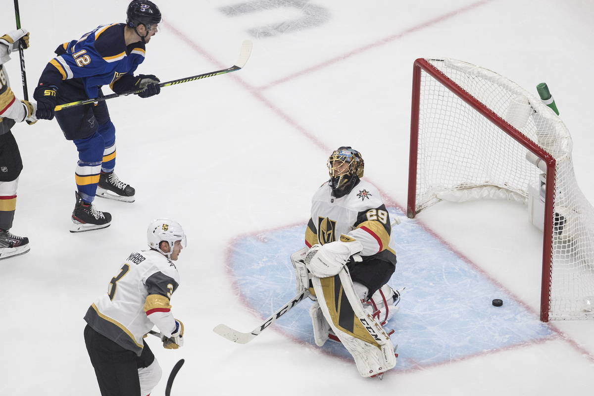 St. Louis Blues' Zach Sanford (12) watches the puck go past Vegas Golden Knights goalie Marc-An ...