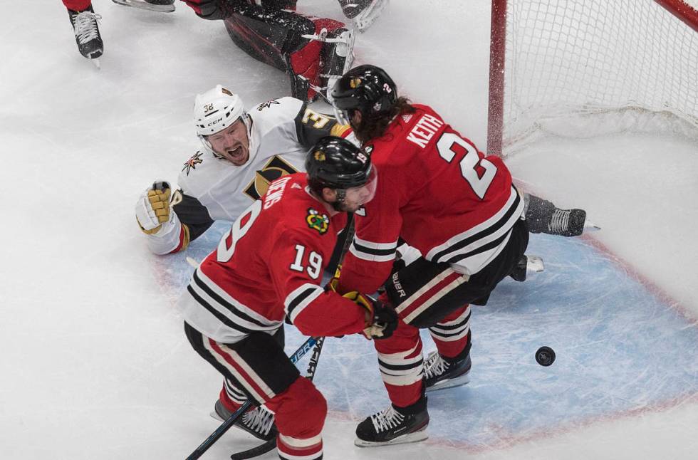 Vegas Golden Knights' Patrick Brown (38) celebrates a goal, next to Chicago Blackhawks' Jonatha ...