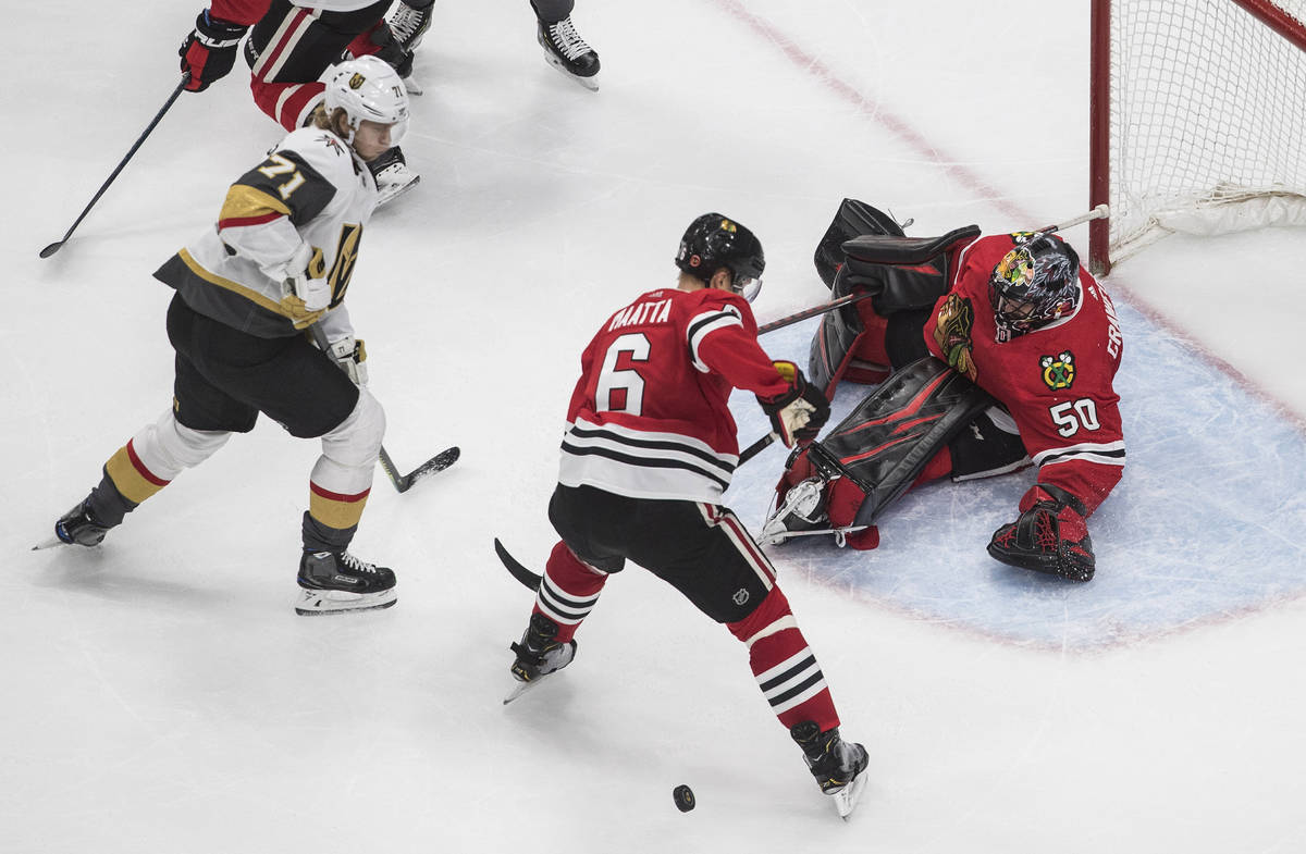 Vegas Golden Knights' William Karlsson (71) is stopped by Chicago Blackhawks goalie Corey Crawf ...