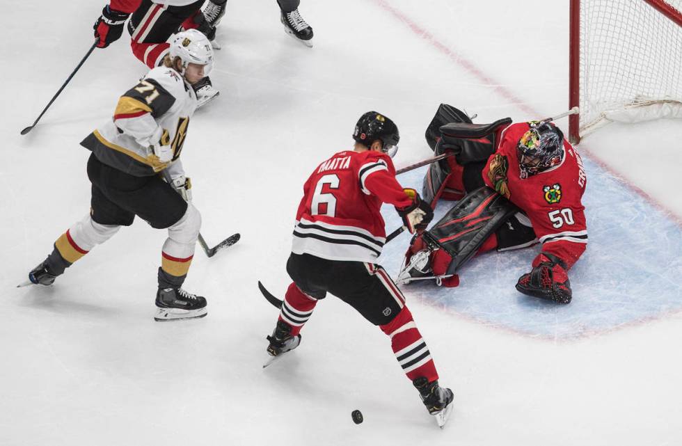 Vegas Golden Knights' William Karlsson (71) is stopped by Chicago Blackhawks goalie Corey Crawf ...