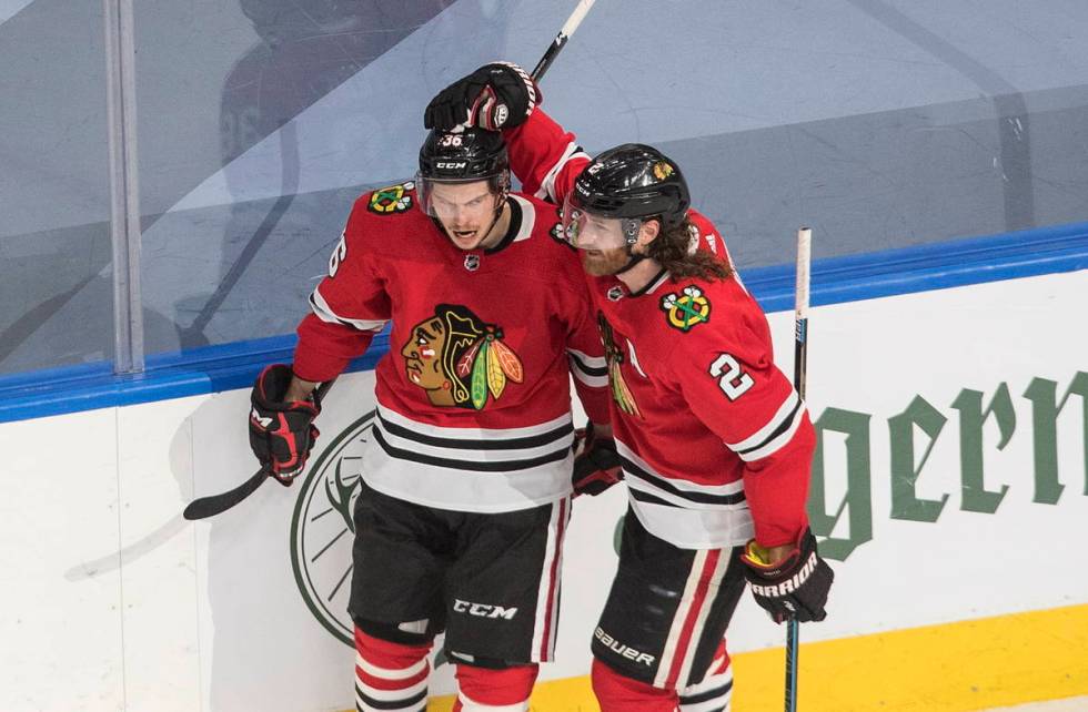 Chicago Blackhawks' Matthew Highmore (36) and Duncan Keith (2) celebrate a goal during first-pe ...