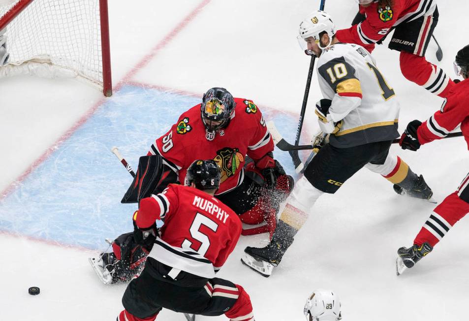 Vegas Golden Knights' Nicolas Roy (10) is stopped by Chicago Blackhawks goalie Corey Crawford ( ...