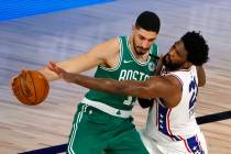 Philadelphia 76ers' Joel Embiid, right, reaches for a steal against Boston Celtics' Enes Kanter ...