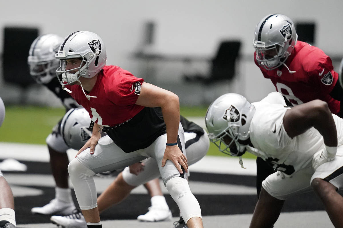 Las Vegas Raiders quarterback Derek Carr (4) stretches during an NFL football training camp pra ...