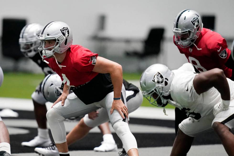 Las Vegas Raiders quarterback Derek Carr (4) stretches during an NFL football training camp pra ...