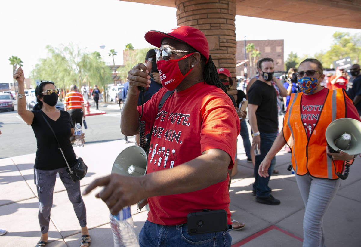 James Reed, Culinary Union Local 226 organizer, shouts slogans as union members rally outside o ...
