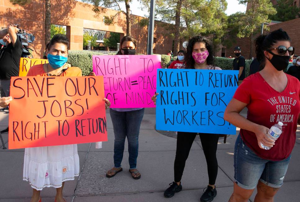 Gabriela Rivera, left, Isabel Macias and Bertha Regalado rally outside of the Clark County Comm ...