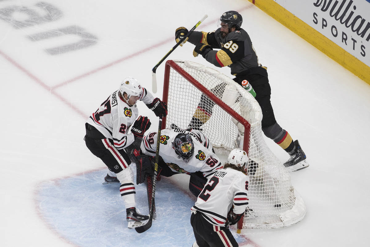 Vegas Golden Knights' Alex Tuch (89) scores on Chicago Blackhawks goalie Corey Crawford (50) as ...