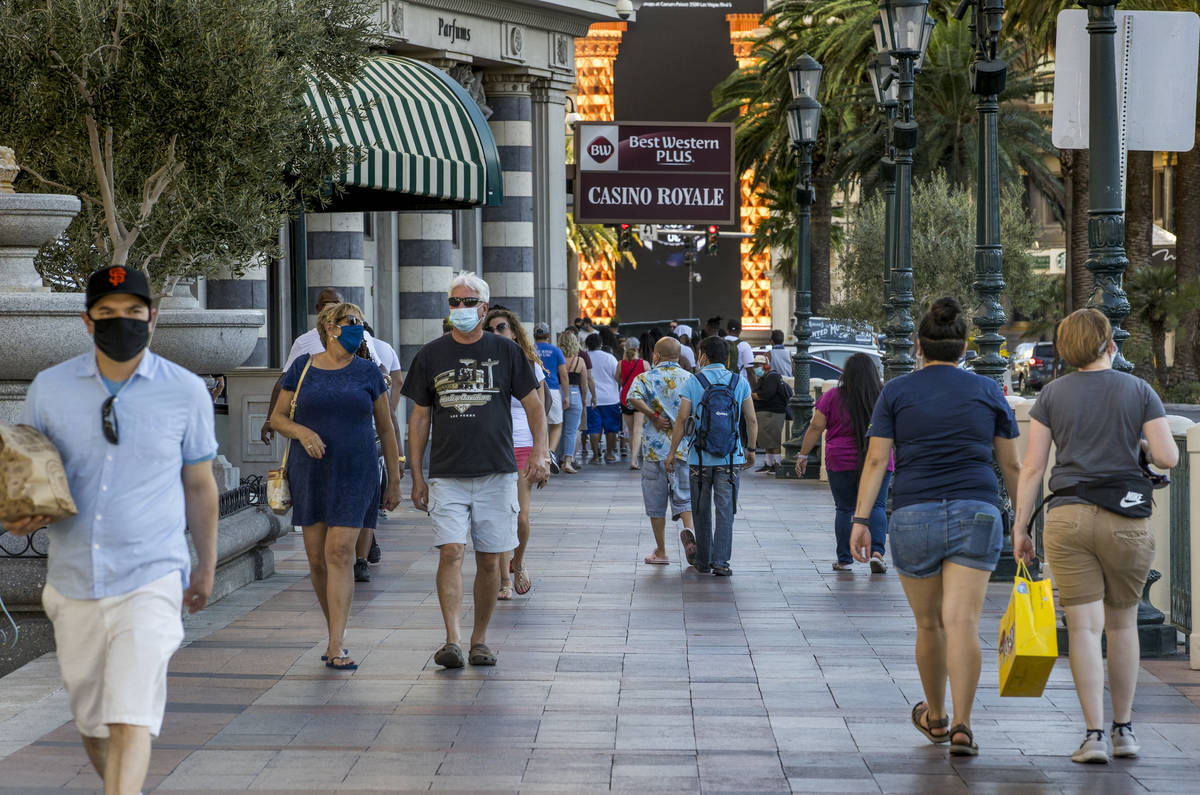 Visitors wander along the Strip on Friday, August 7, 2020, in Las Vegas. The Las Vegas Conventi ...