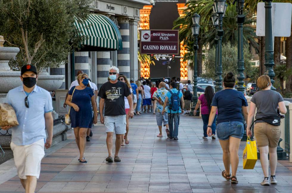 Visitors wander along the Strip on Friday, August 7, 2020, in Las Vegas. The Las Vegas Conventi ...