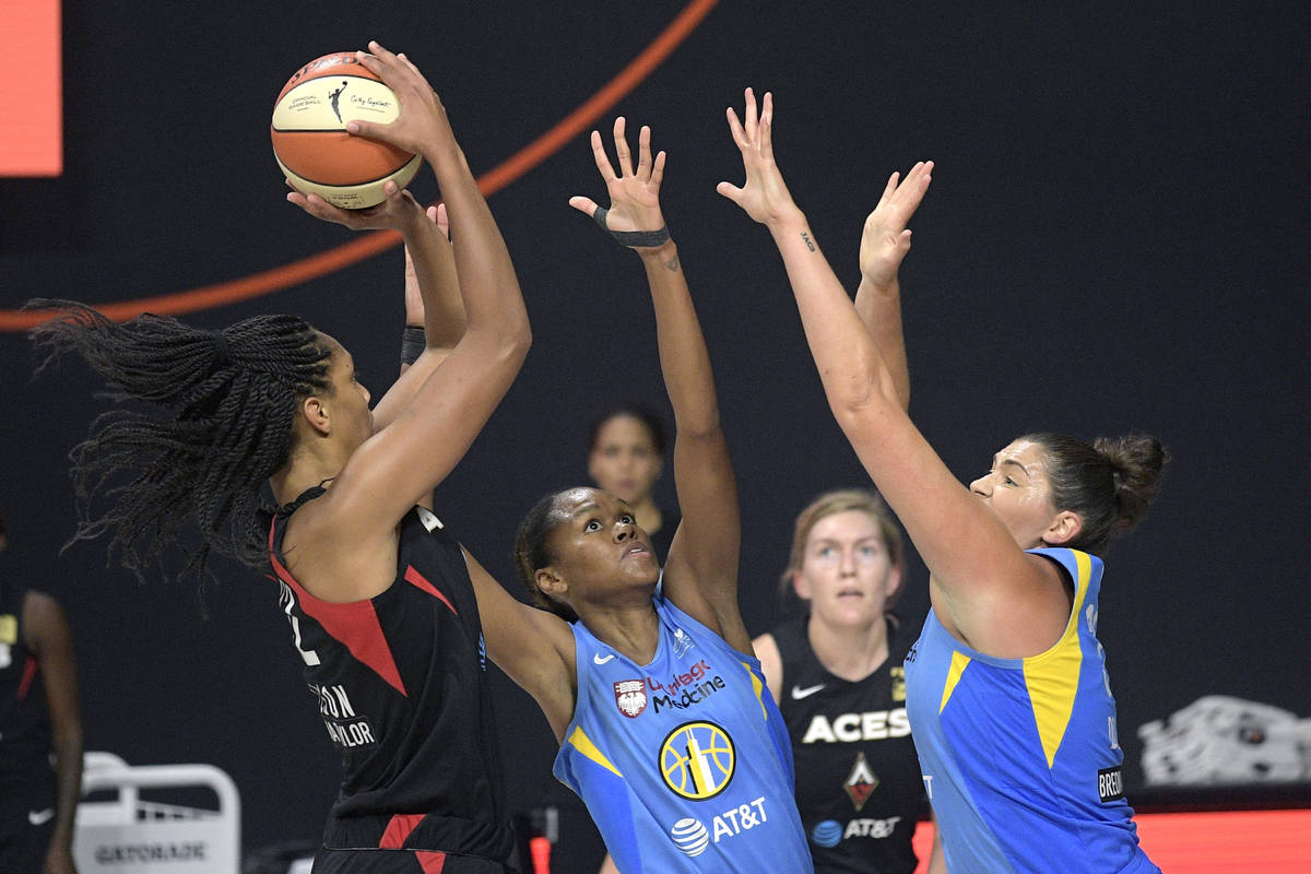 Las Vegas Aces center A'ja Wilson, left, goes up for a shot in front of Chicago Sky forward Azu ...