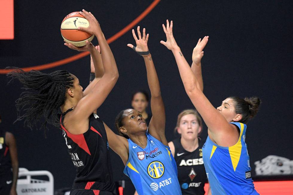Las Vegas Aces center A'ja Wilson, left, goes up for a shot in front of Chicago Sky forward Azu ...