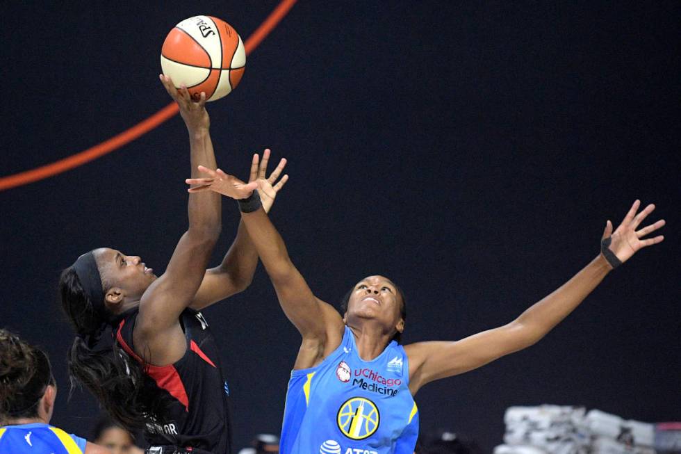 Las Vegas Aces guard Jackie Young, left, goes up for a shot in front of Chicago Sky forward Azu ...