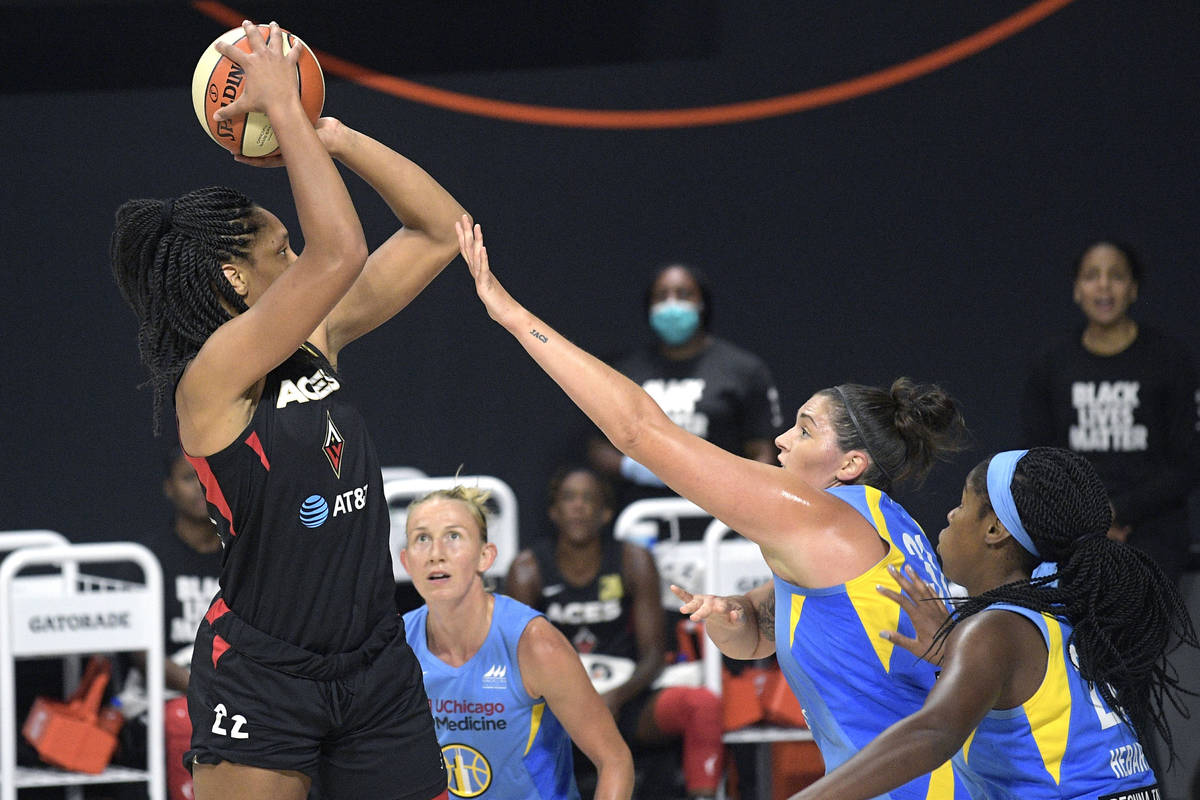 Las Vegas Aces center A'ja Wilson (22) goes up for a shot in front of Chicago Sky guard Courtne ...