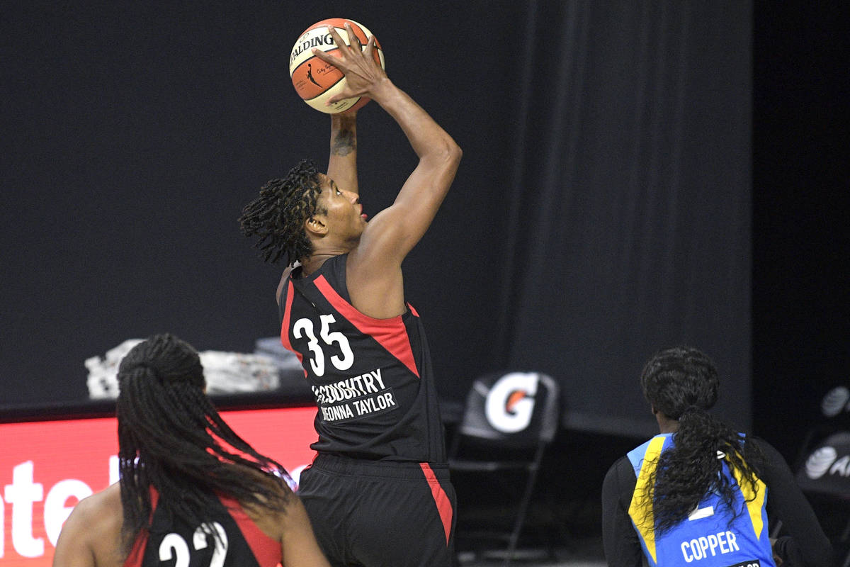 Las Vegas Aces forward Angel McCoughtry (35) goes up for a shot in front of Chicago Sky guard K ...