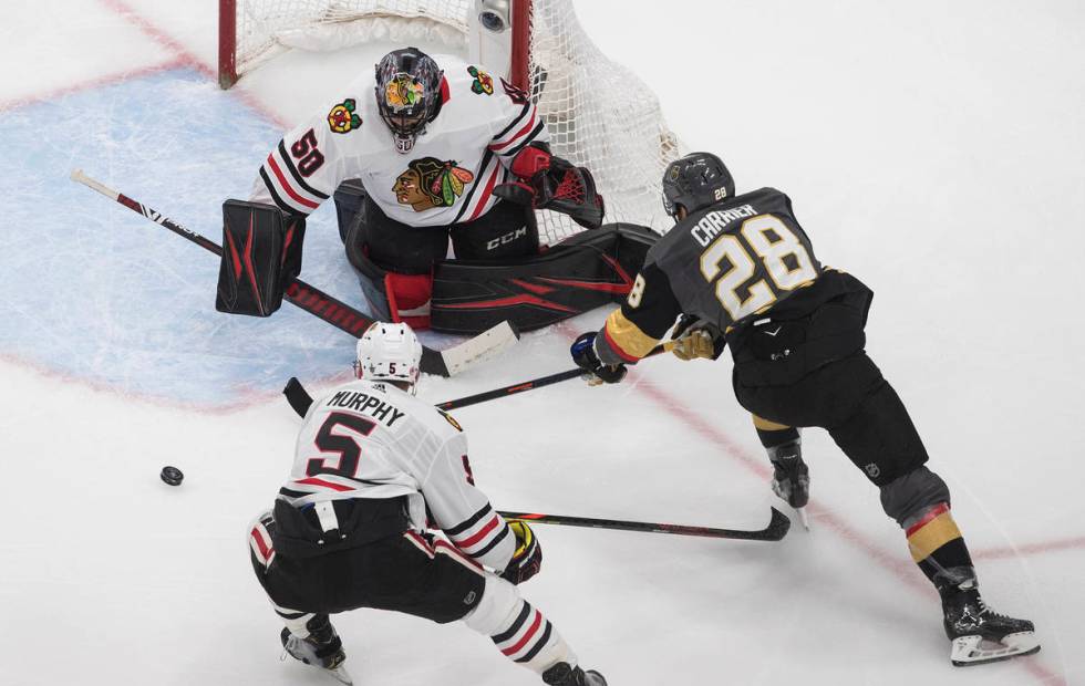 Vegas Golden Knights' William Carrier (28) is stopped by Chicago Blackhawks goalie Corey Crawfo ...