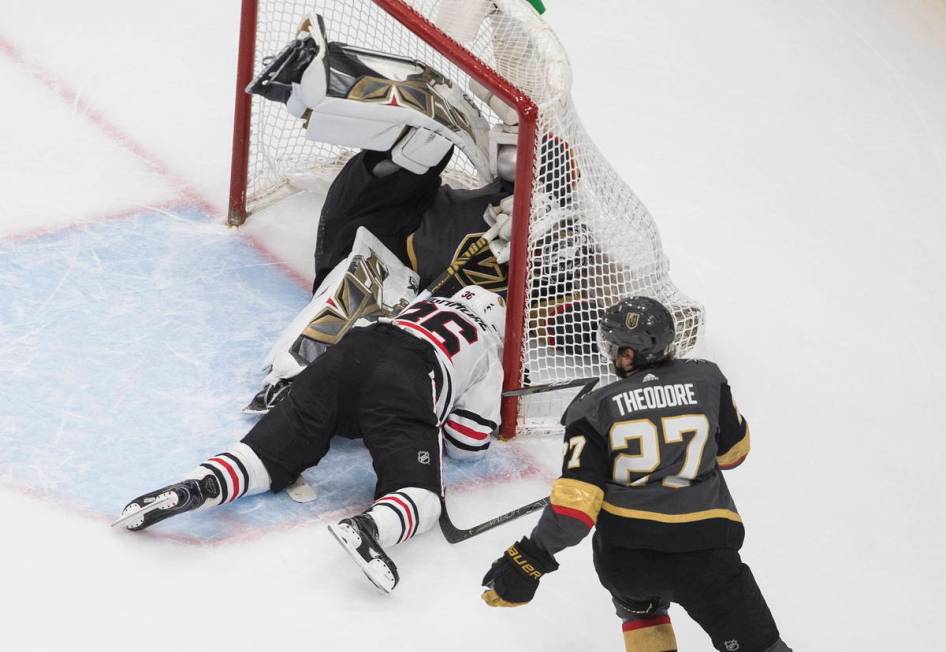 Chicago Blackhawks' Robin Lehner (16) crashes against Vegas Golden Knights goalie Robin Lehner ...