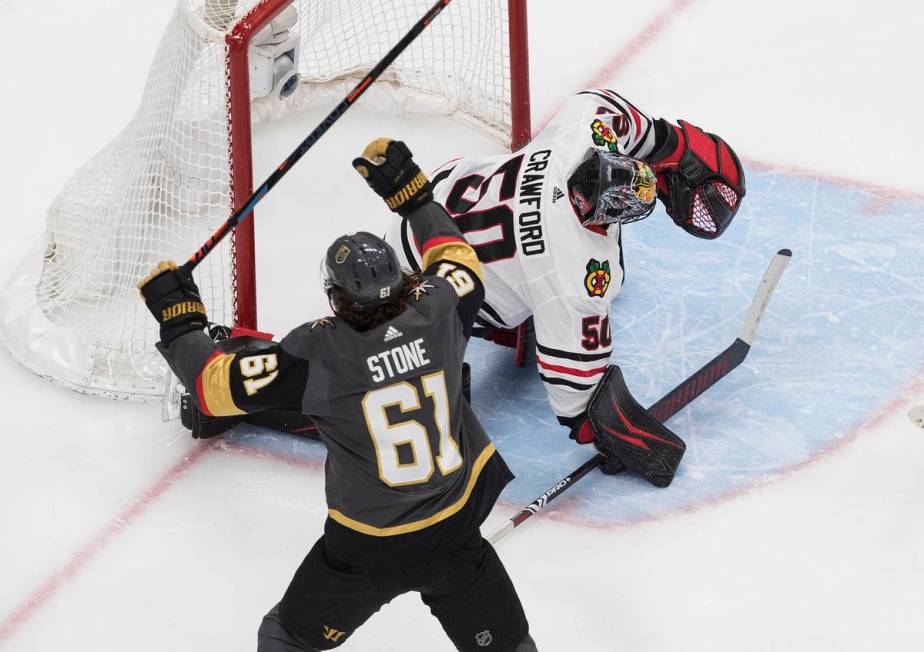 Vegas Golden Knights' Mark Stone (61) celebrates a goal on Chicago Blackhawks goalie Corey Craw ...