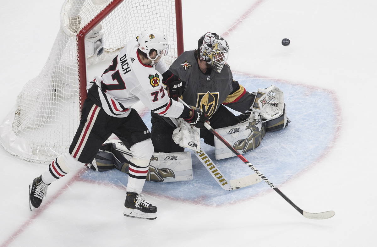 Vegas Golden Knights goalie Robin Lehner (90) makes a save as Chicago Blackhawks' Kirby Dach (7 ...