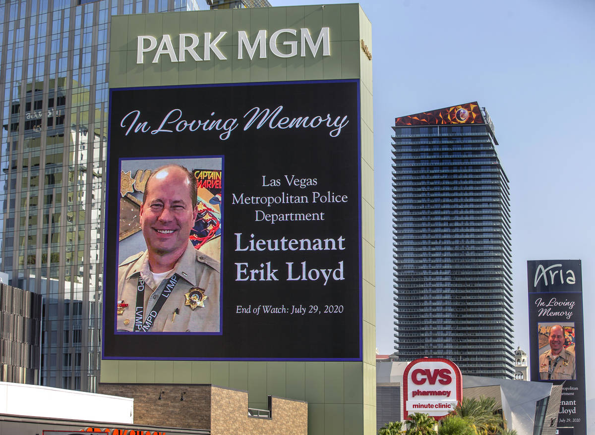 The marquee at Park MGM honors Las Vegas police Lt. Erik Lloyd as his funeral procession moves ...