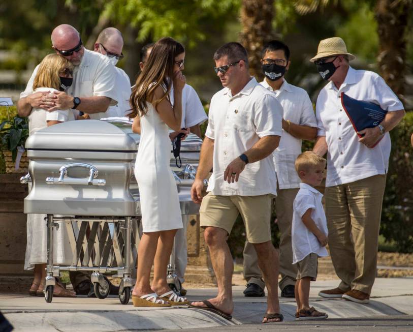 Mourners gather about the casket during a burial service for Metro Lt. Erik Lloyd at the Palm N ...