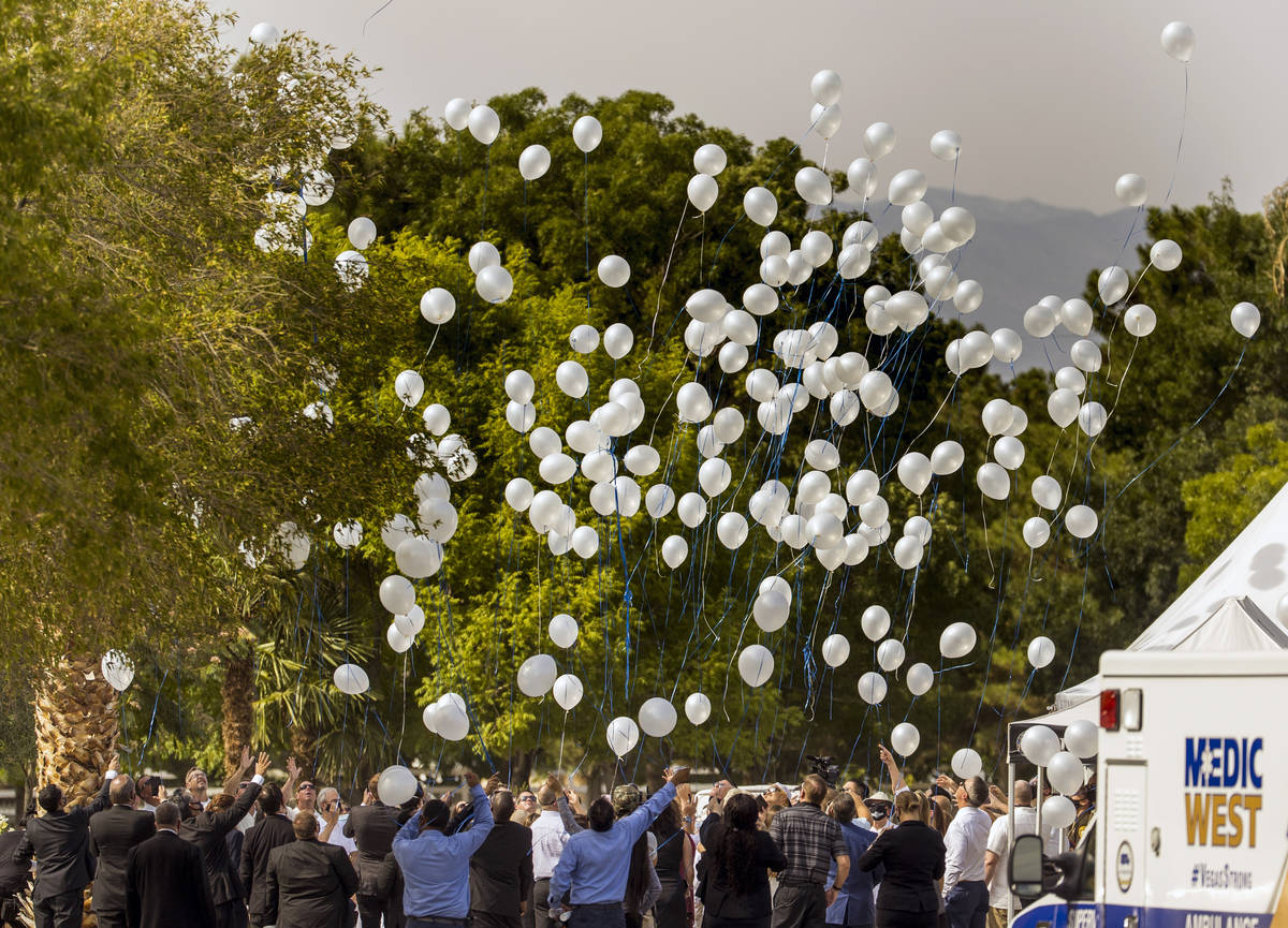 Balloons are launched commencing a burial service for Metro Lt. Erik Lloyd at the Palm Northwes ...