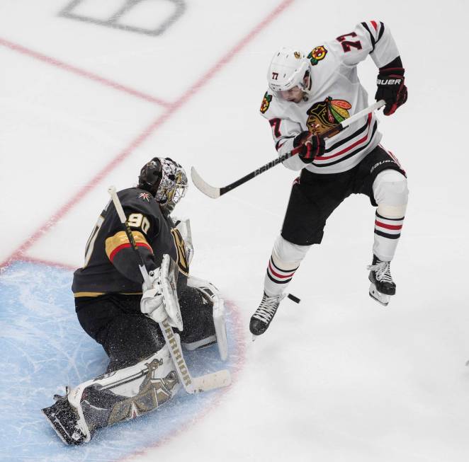 Vegas Golden Knights goalie Robin Lehner (90) makes a save as Chicago Blackhawks' Kirby Dach (7 ...