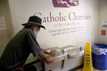 Nathan Shapiro fills his water bottle at Catholic Charities day shelter in downtown Las Vegas, ...