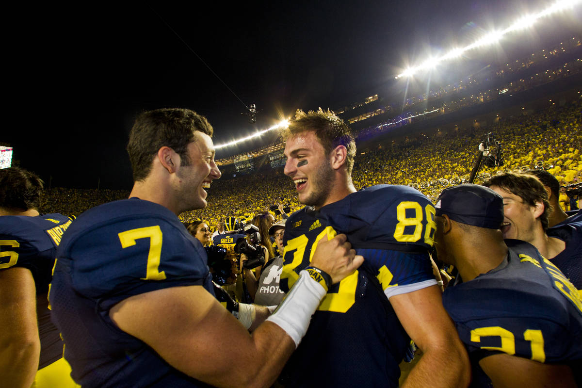 Michigan quarterback Shane Morris (7) celebrates with tight end Jake Butt (88) after an NCAA co ...