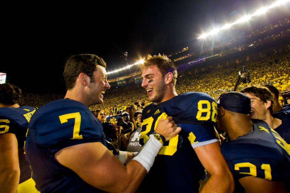 Michigan quarterback Shane Morris (7) celebrates with tight end Jake Butt (88) after an NCAA co ...