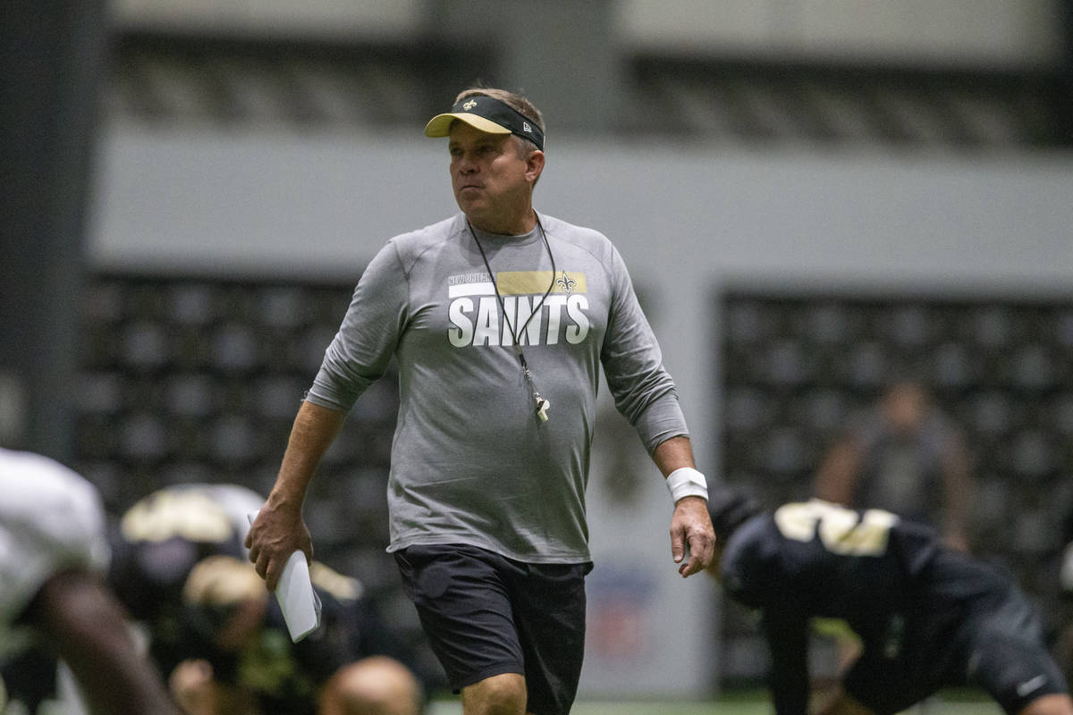 New Orleans Saints head coach Sean Payton watches the team stretch during an NFL football train ...