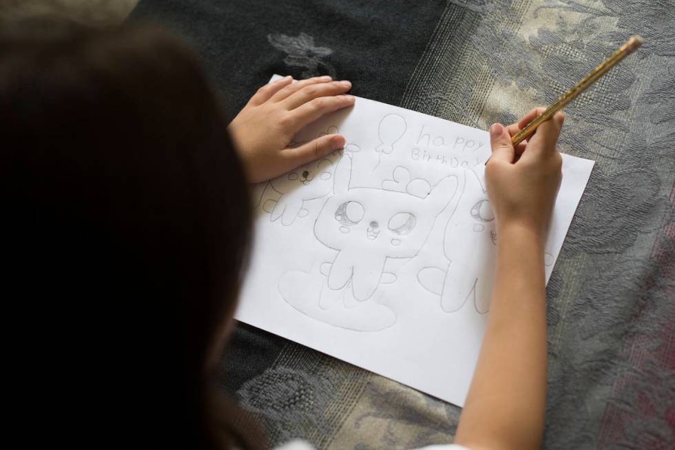 Sofia Hall, 8, draws at her home in Las Vegas, Wednesday, Aug. 19, 2020. Hall is the Nevada win ...