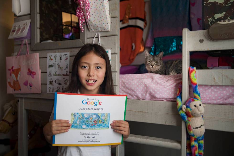 Sofia Hall, 8, holds up her Doodle for Google next to her cat Murphy at her home in Las Vegas, ...