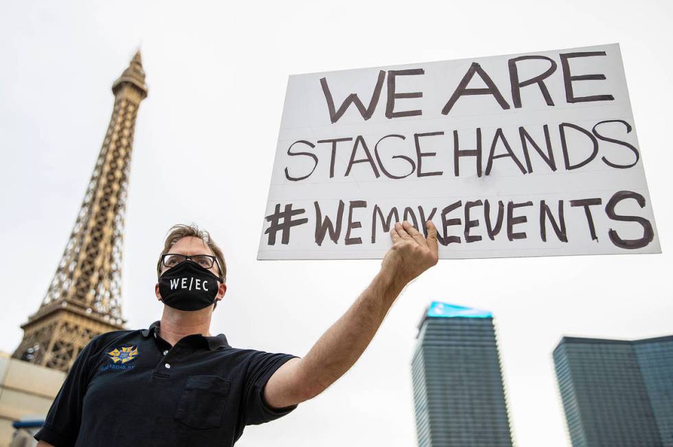 Eric Johnson holds a sign during an event to raise awareness about the plight of the local ente ...