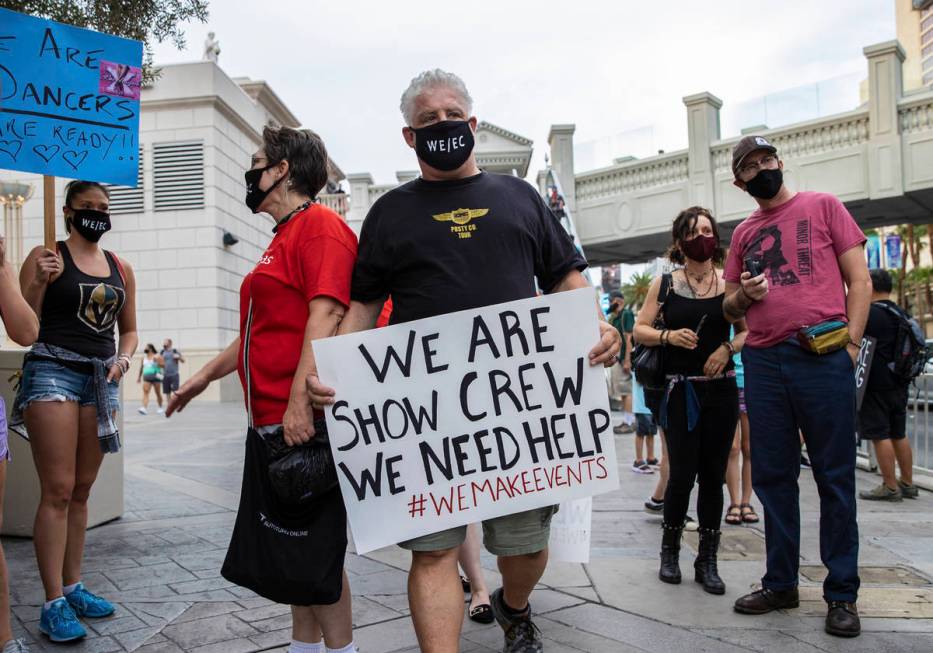 Thomas Morris carries a sign during an event to raise awareness about the plight of the local e ...