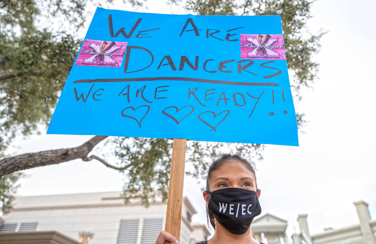 Danielle Aveyard holds a sign during an event to raise awareness about the plight of the local ...