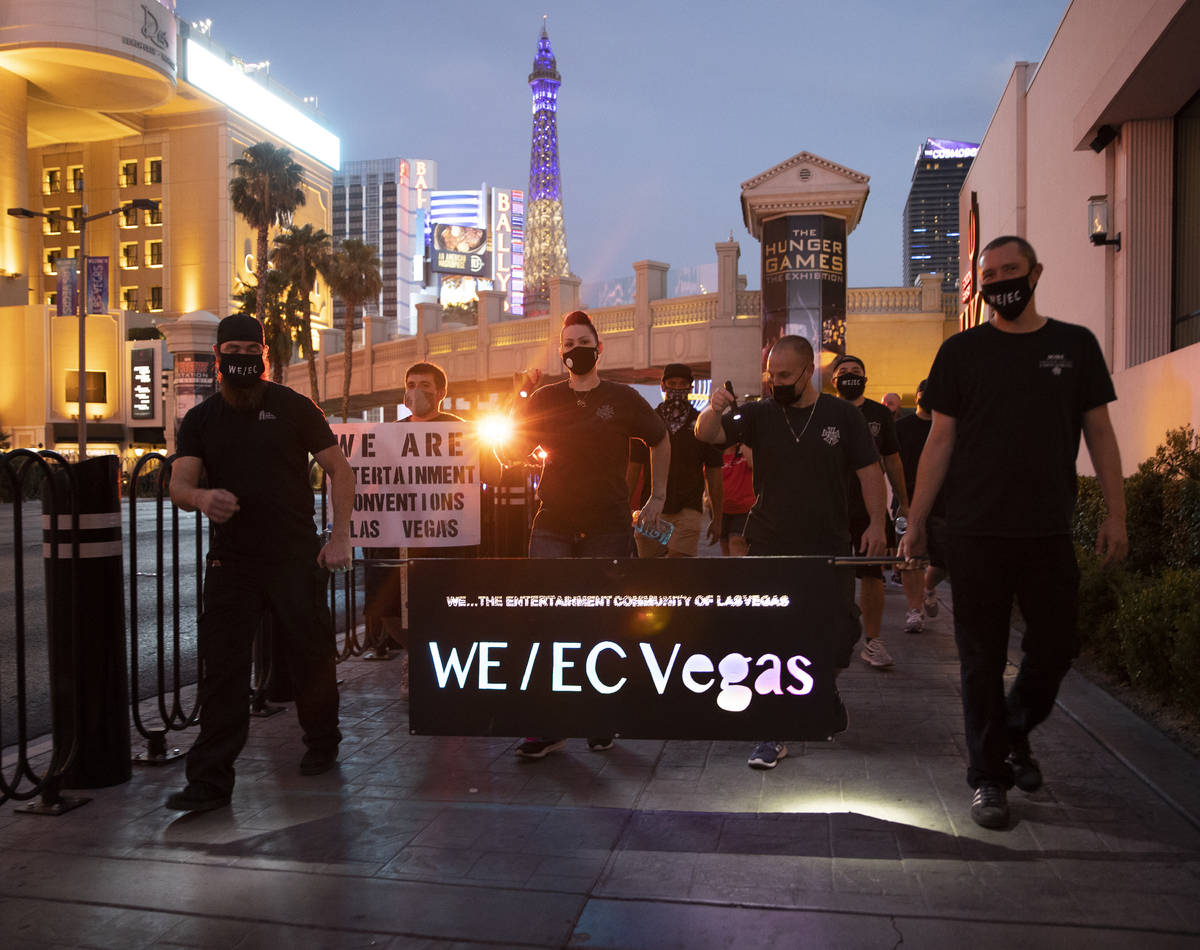 Entertainment workers march south on the Strip during an event to raise awareness about the pli ...