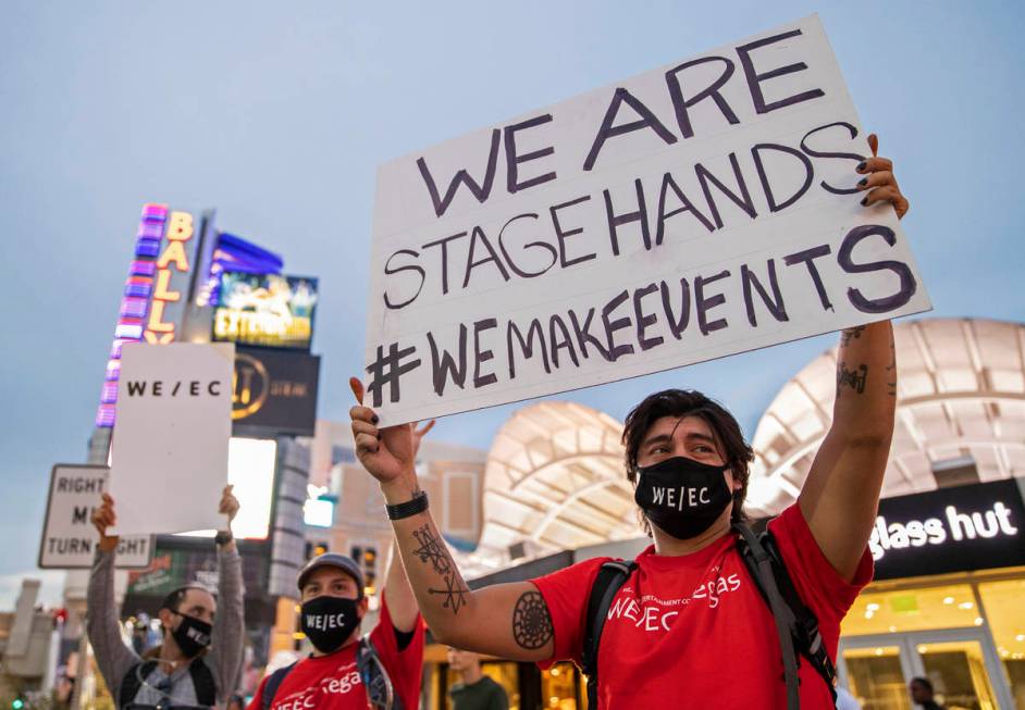 Joseppe Martinez, right, holds a sign during an event to raise awareness about the plight of th ...