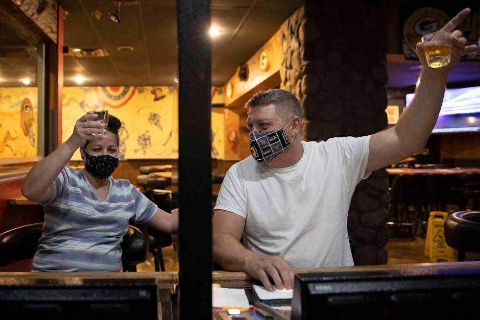 John Adler, right, and Norma Jean Aguilar lift their glasses during a last call toast at Jackso ...