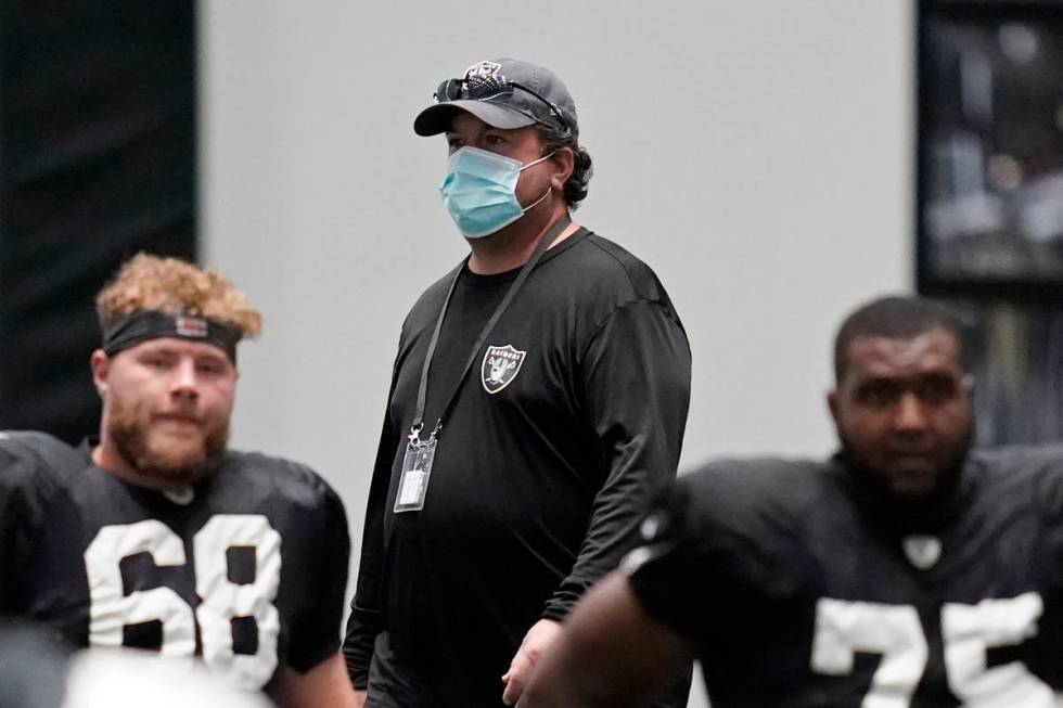 Raiders defensive coordinator Paul Guenther walks on the field during an NFL football training ...