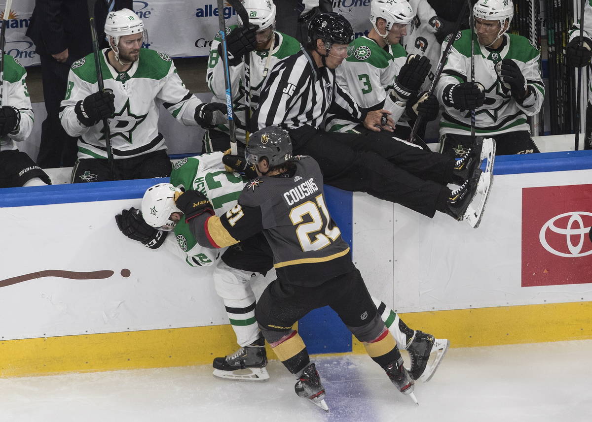 Dallas Stars' Radek Faksa (12) is checked by Vegas Golden Knights' Nick Cousins (21) during the ...