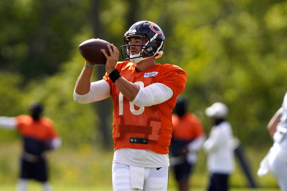 Chicago Bears quarterback Mitchell Trubisky looks at a ball during an NFL football camp practic ...