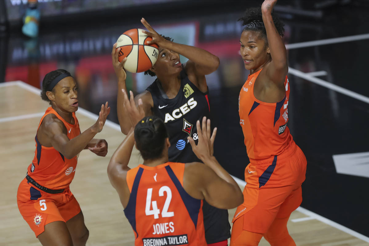 Las Vegas Aces' Angel McCoughtry tries to shoot against the Connecticut Sun defense by Jasmine ...